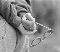 Glasses held behind her back